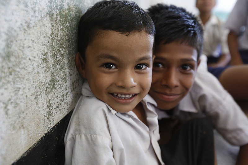 Two young boys smiling at the camera.